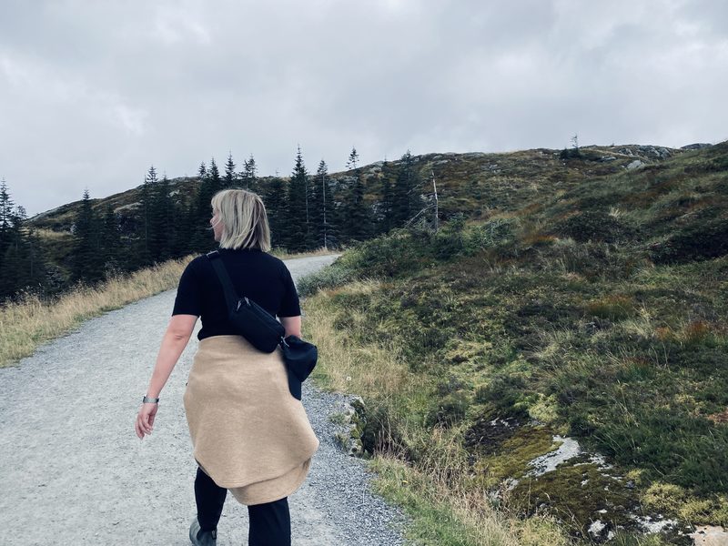 Heather using her Towpath Pack in size small on a hike